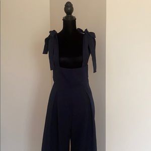 Navy blue jumper with ties.